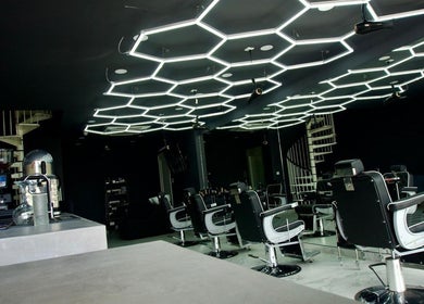 Modern interior at PLAN B | THE STRAND in Tas-sliema, MT with unique ceiling lights and barber chairs.