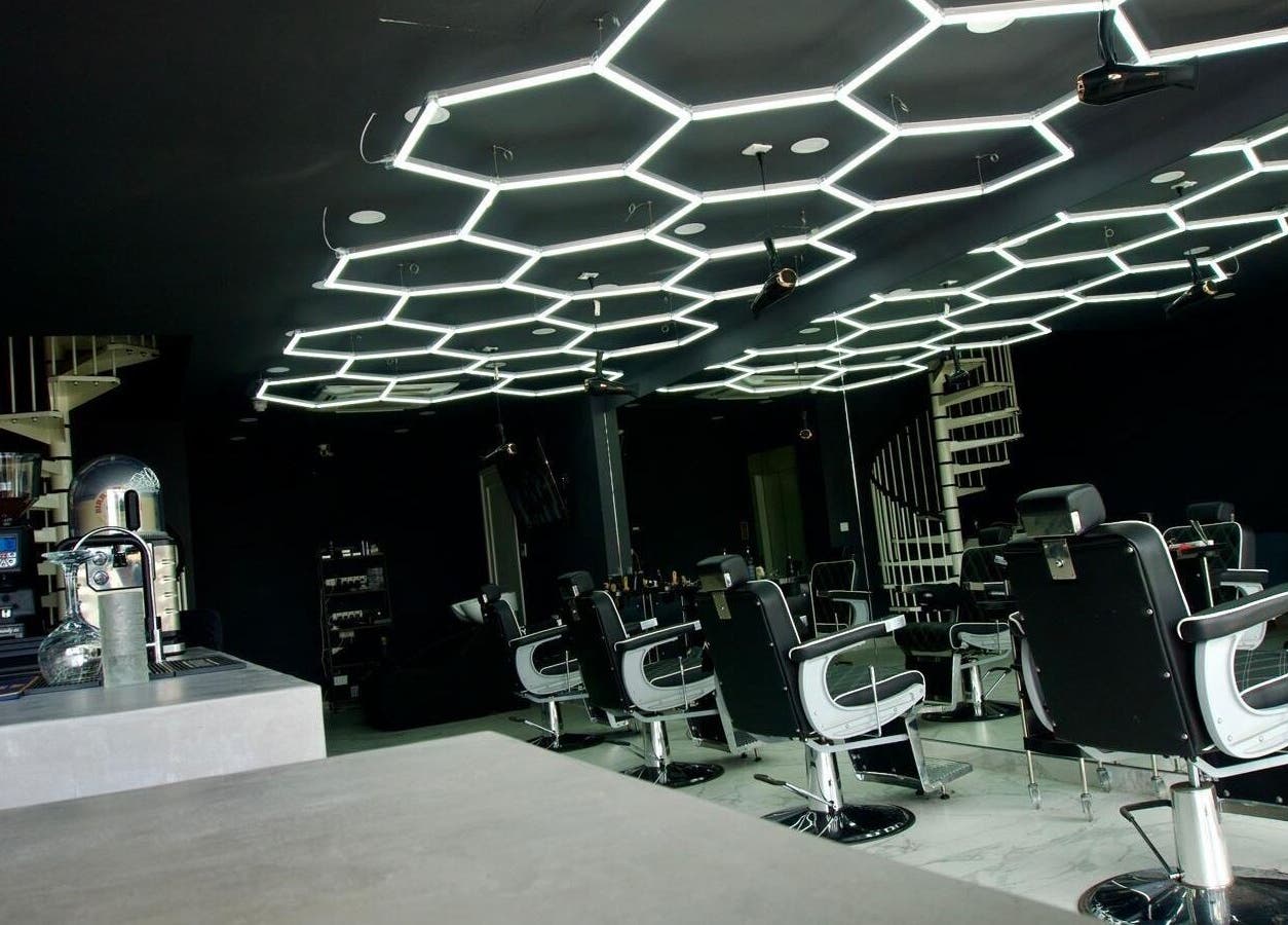 Modern interior of PLAN B | THE STRAND salon in Tas-sliema, MT with unique geometric lighting.