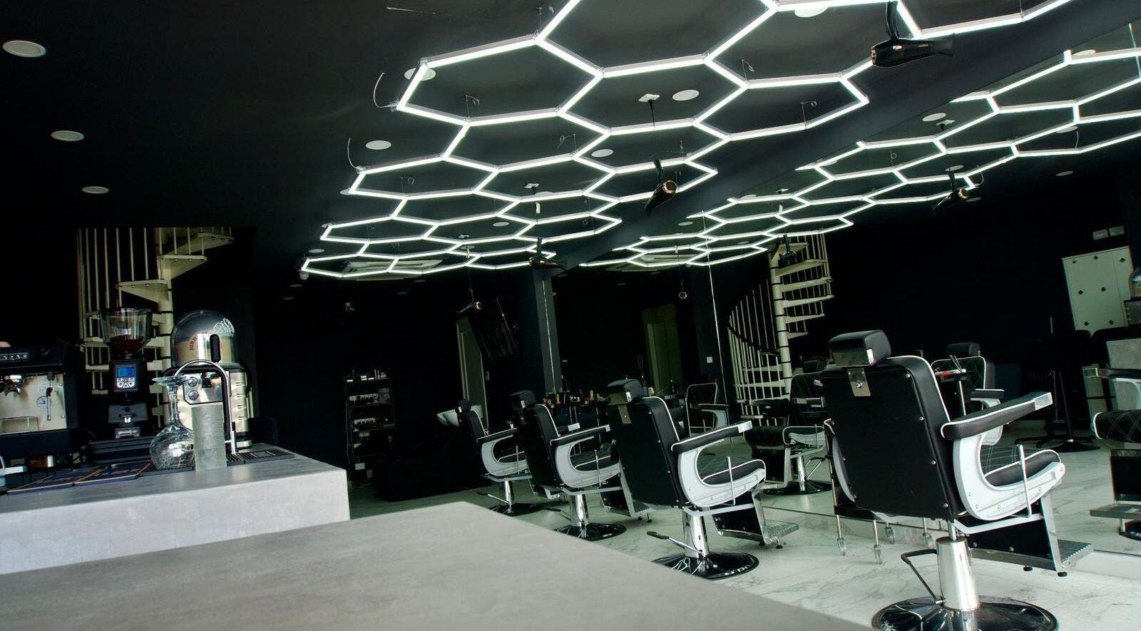 Modern interior of PLAN B | THE STRAND salon in Tas-sliema, MT with unique geometric lighting.