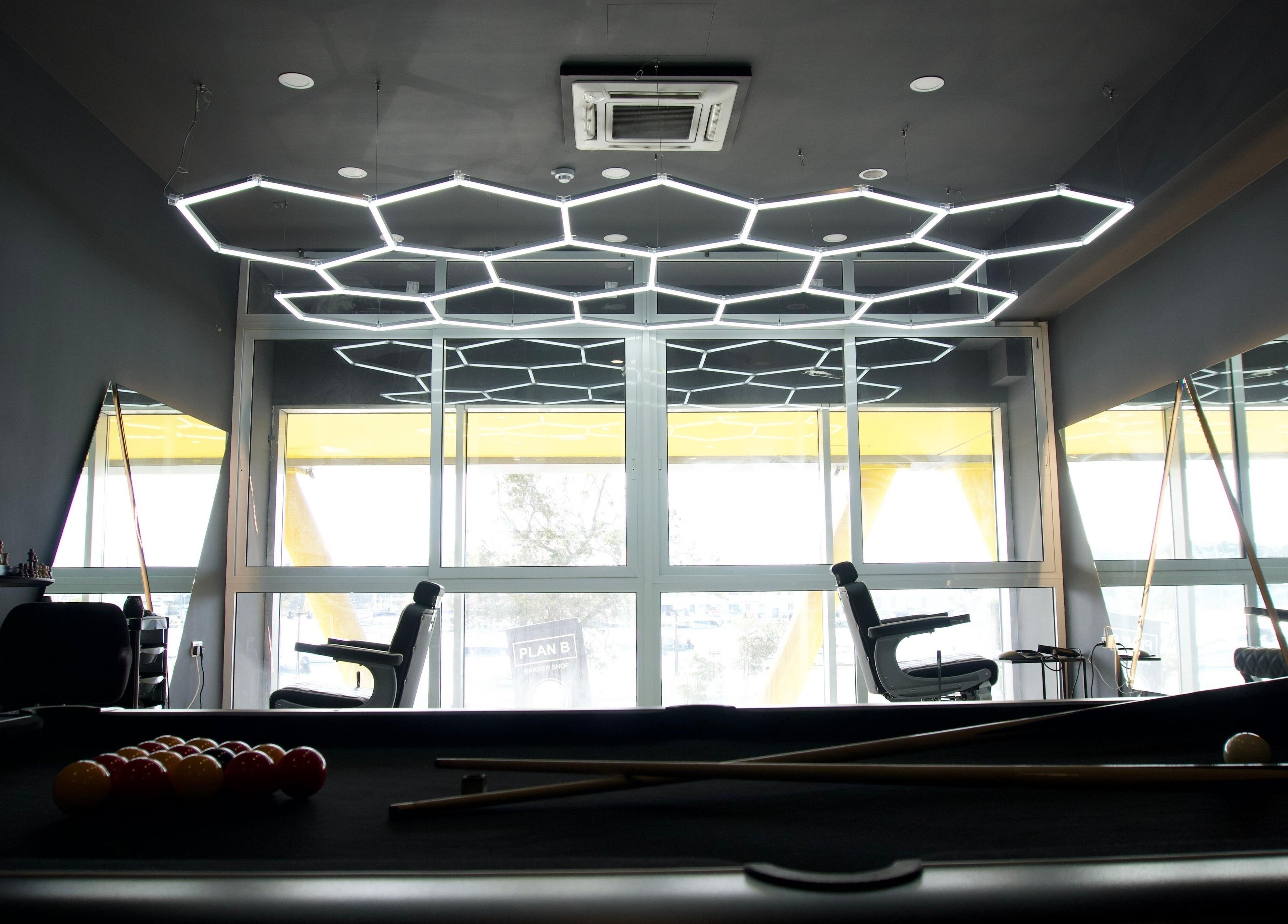 Modern lounge at PLAN B | THE STRAND, Tas-sliema, MT with geometric lights and pool table.