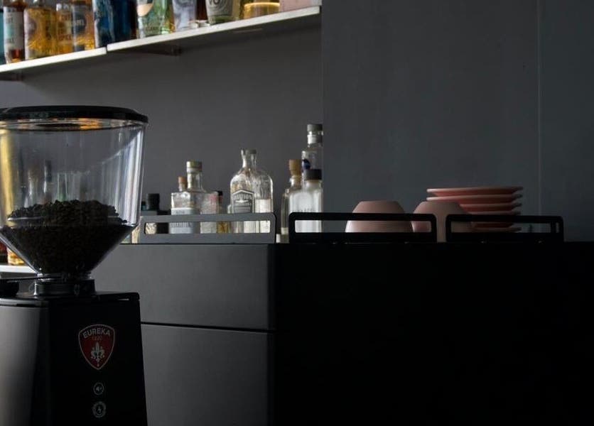 Modern coffee corner at PLAN B | THE STRAND, Tas-sliema, MT with espresso machine and stylish shelving.