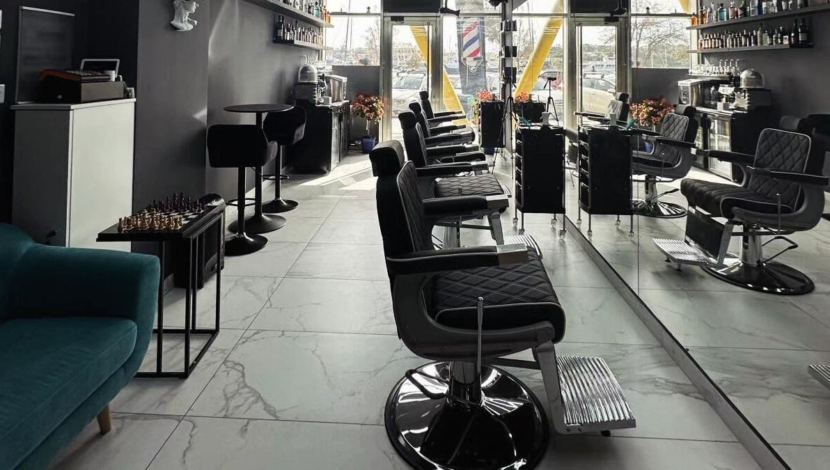 Stylish salon interior at PLAN B | St. Paul’s Hilton, San Pawl Il-baħar, MT with modern barber chairs.