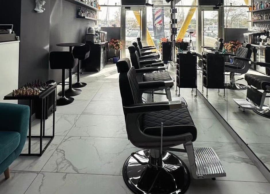 Stylish salon interior at PLAN B | St. Paul’s Hilton, San Pawl Il-baħar, MT with modern barber chairs.
