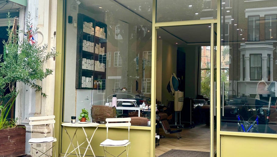 SetbyFloss salon entrance in London, England, GB, displaying stylish chairs and decorative plants.