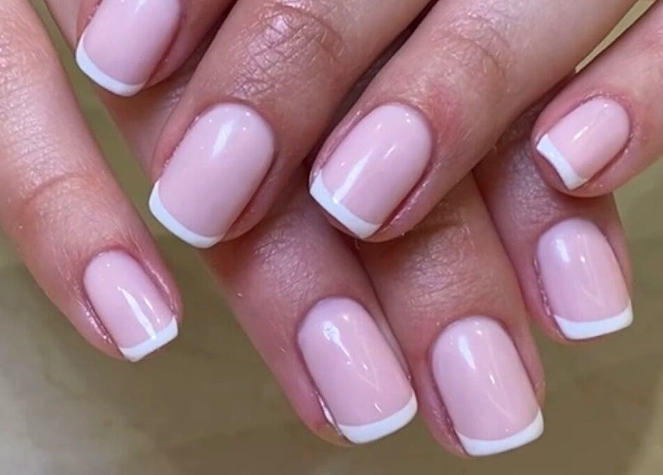 Elegant French manicure nail art at SetbyFloss, London, England, GB. Perfectly cut and polished nails.