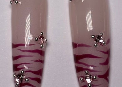 Elegant nail art with pink zebra stripes and rhinestones at SetbyFloss, London, England, GB.