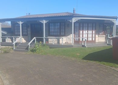 Inviting exterior of Massage Em, Morrinsville, Waikato, NZ, showcasing its cozy entrance and tranquil setting.