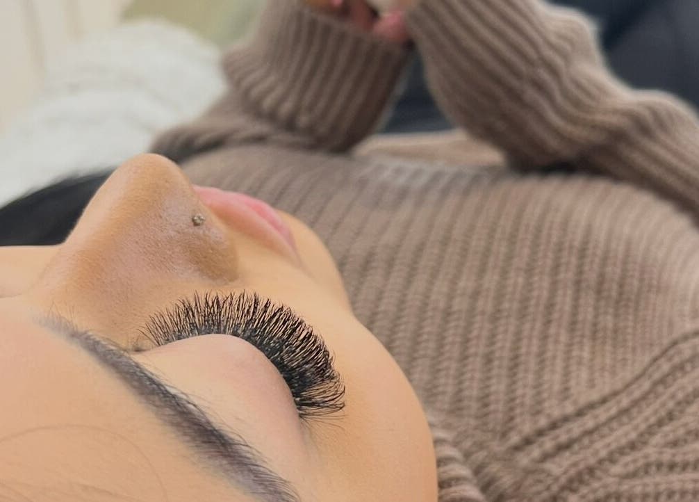 Eyelash extension treatment at Eye Beautify Bondi, Bondi Junction, New South Wales, AU. Woman in cozy sweater.