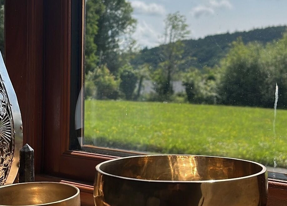 View from Hummingbird Haven in Bray, County Wicklow, IE, showing singing bowls by a sunlit window.
