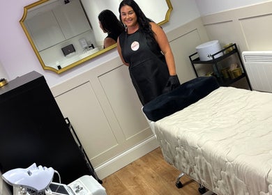 Treatment room at The Beauty Loft, Kirkby In Ashfield, England, GB with a smiling therapist ready to assist.