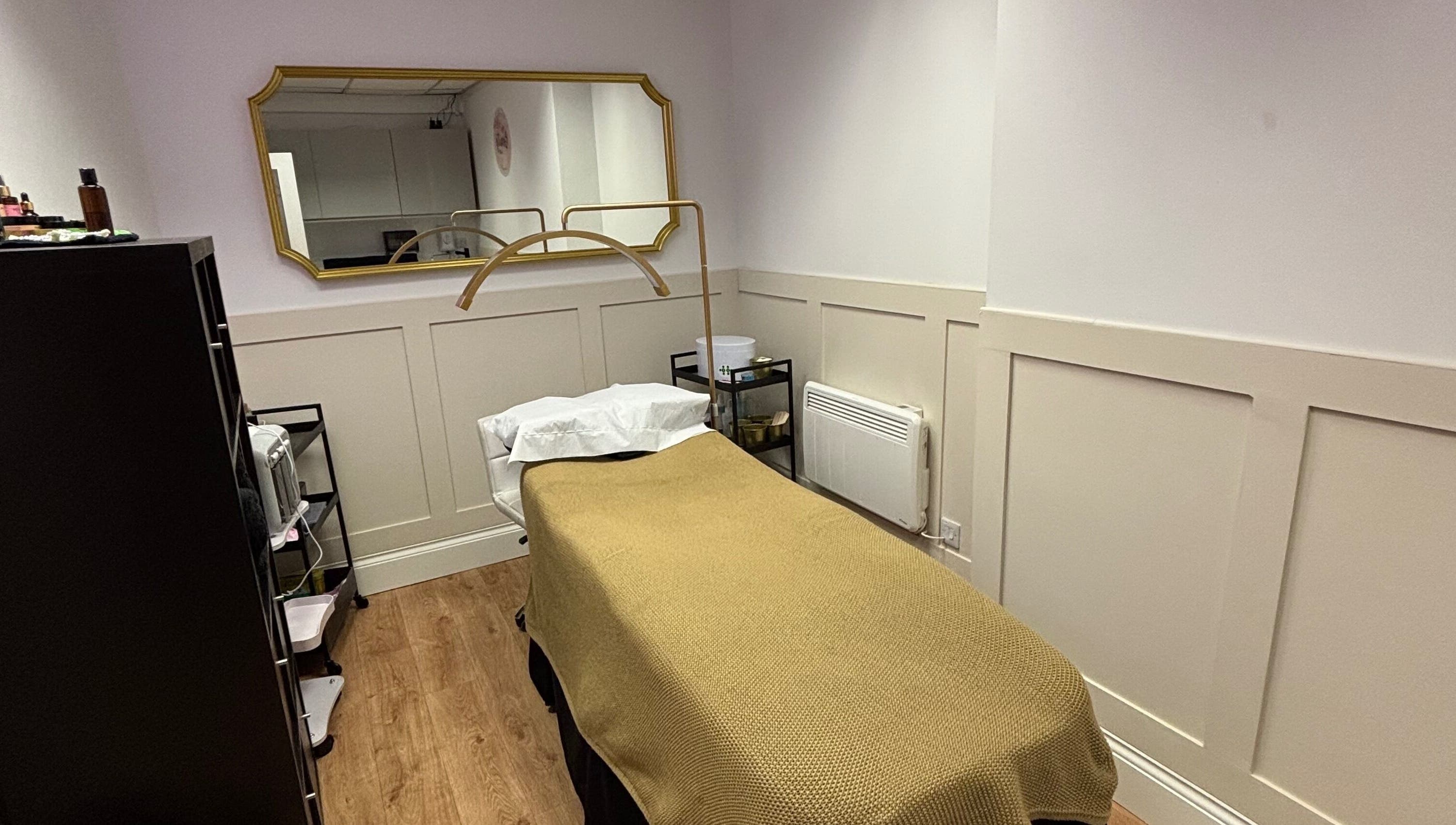 Tranquil therapy room at The Beauty Loft, Kirkby In Ashfield, England, GB with a cozy bed and mirror.