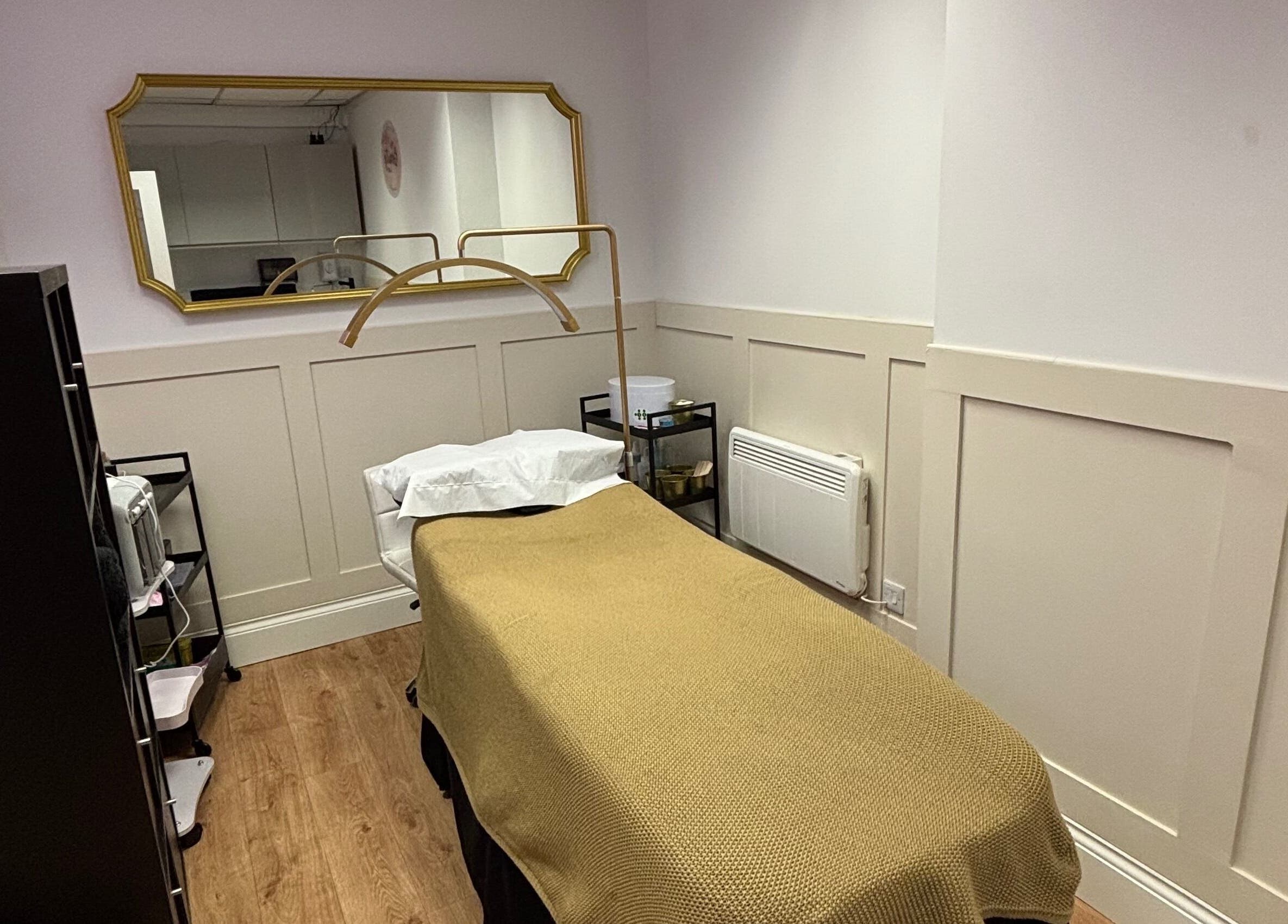 Tranquil therapy room at The Beauty Loft, Kirkby In Ashfield, England, GB with a cozy bed and mirror.