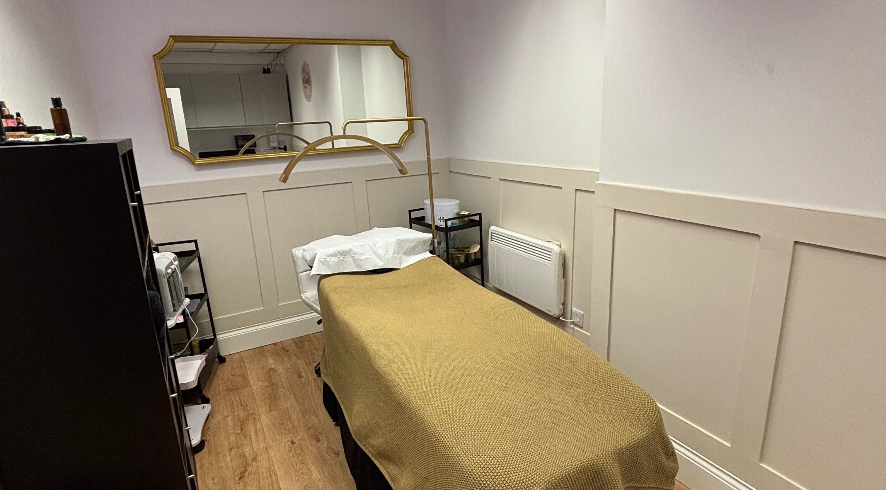 Tranquil therapy room at The Beauty Loft, Kirkby In Ashfield, England, GB with a cozy bed and mirror.