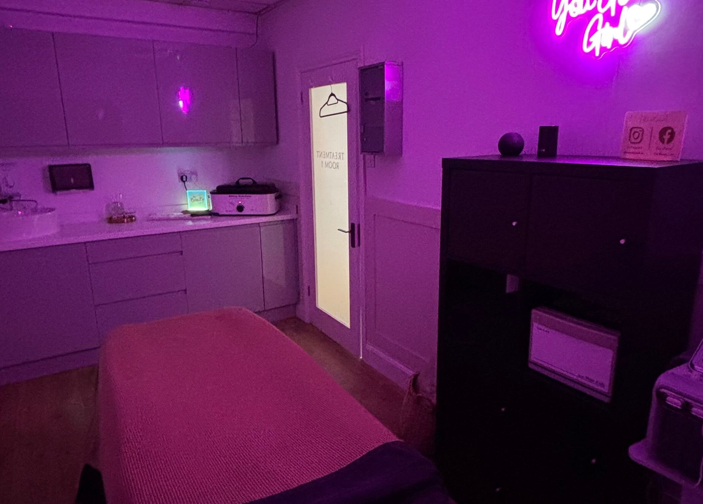 Relaxing treatment room at The Beauty Loft, Kirkby In Ashfield, England, GB, with soothing purple lighting.