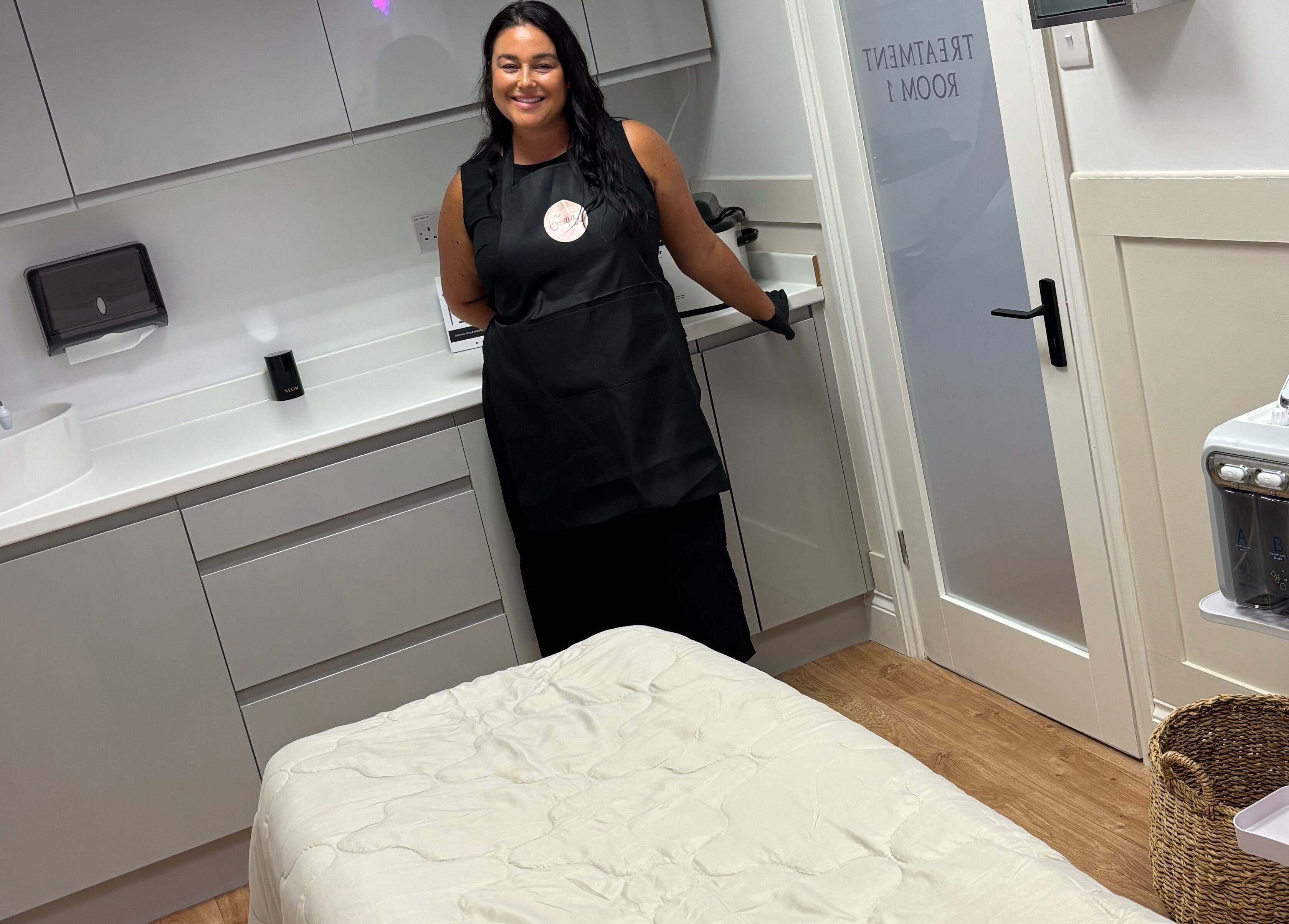 Well-lit treatment room at The Beauty Loft, Kirkby In Ashfield, England, GB, featuring massage bed and smiling staff.
