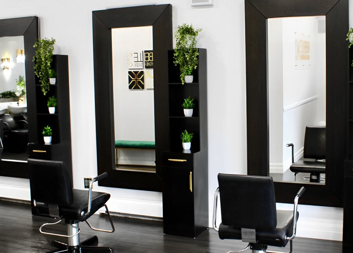 Elegant salon stations at Rebelle X Health & Beauty Spa, North Massapequa, New York, US, with sleek styling chairs.