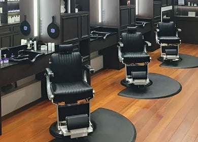 Elegant barber chairs at The British Barbers, Singapore, SG, showcasing a modern grooming ambiance.