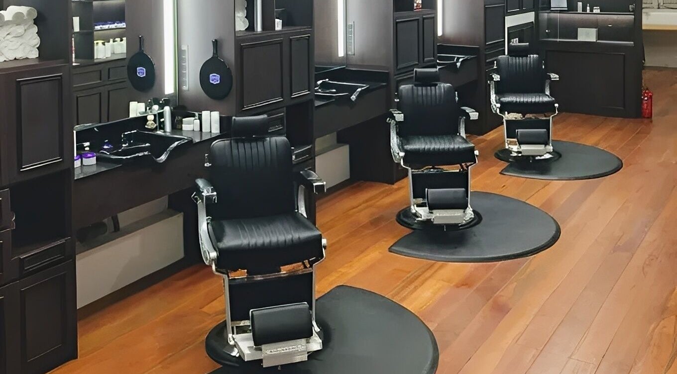 Elegant barber chairs at The British Barbers, Singapore, SG, showcasing a modern grooming ambiance.