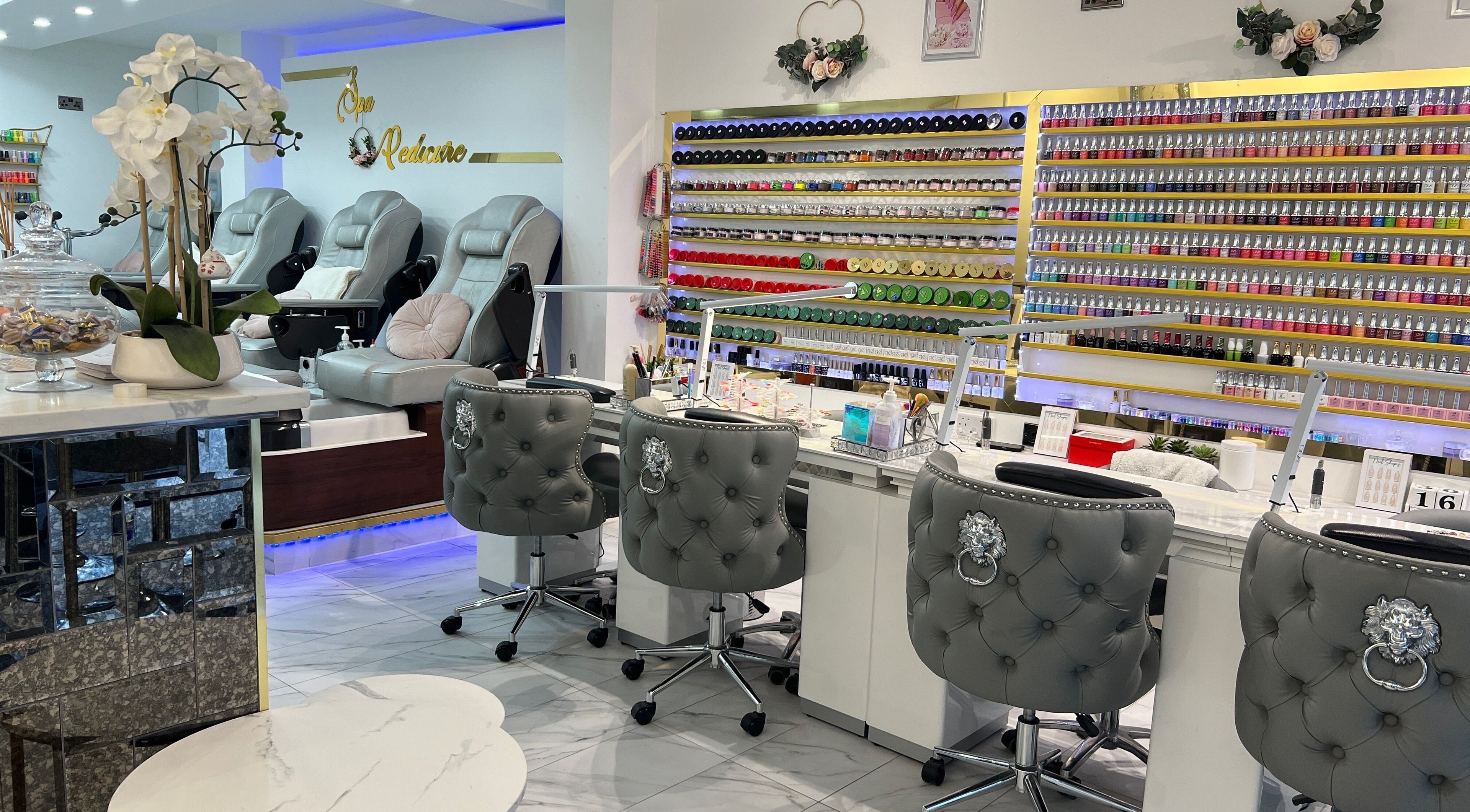Elegant nail spa at Amore Shoreditch, London, England, GB, with plush chairs and a vast nail polish selection.
