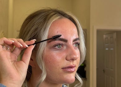 Woman shaping eyebrows with spoolie at Henley House, Henley-in-arden, England, GB.