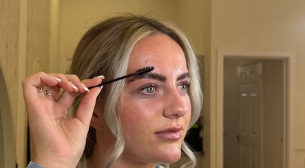 Woman shaping eyebrows with spoolie at Henley House, Henley-in-arden, England, GB.