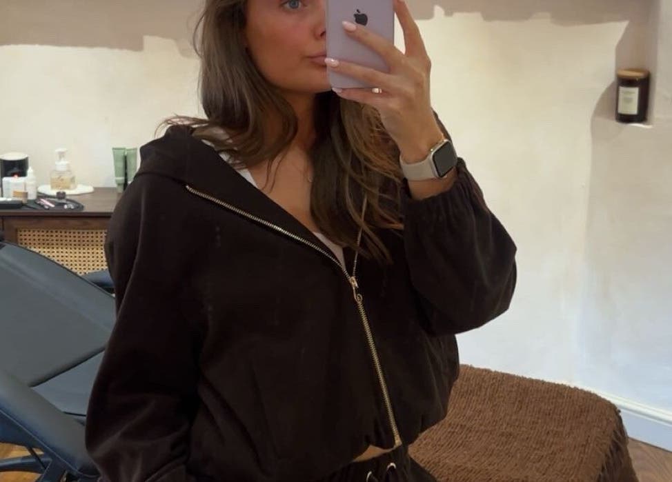 Inside Brows at Henley House, Henley-in-Arden, treatment room with a woman posing in front of a chair.