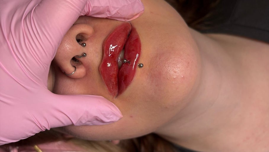 Stylish lip piercings at Shine By S, Peterborough, England, GB. Close-up showing detailed artistry and care.