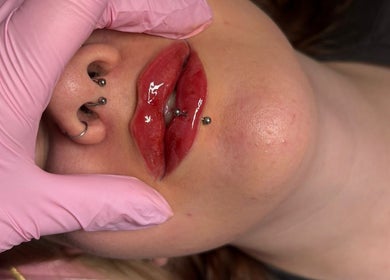 Stylish lip piercings at Shine By S, Peterborough, England, GB. Close-up showing detailed artistry and care.