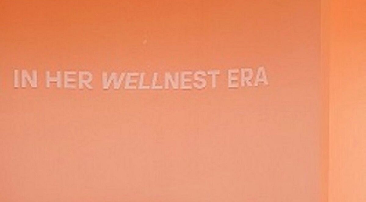 Peach wall with 'In Her Wellnest Era' text at Nest Retreat, Putrajaya, Selangor, MY.