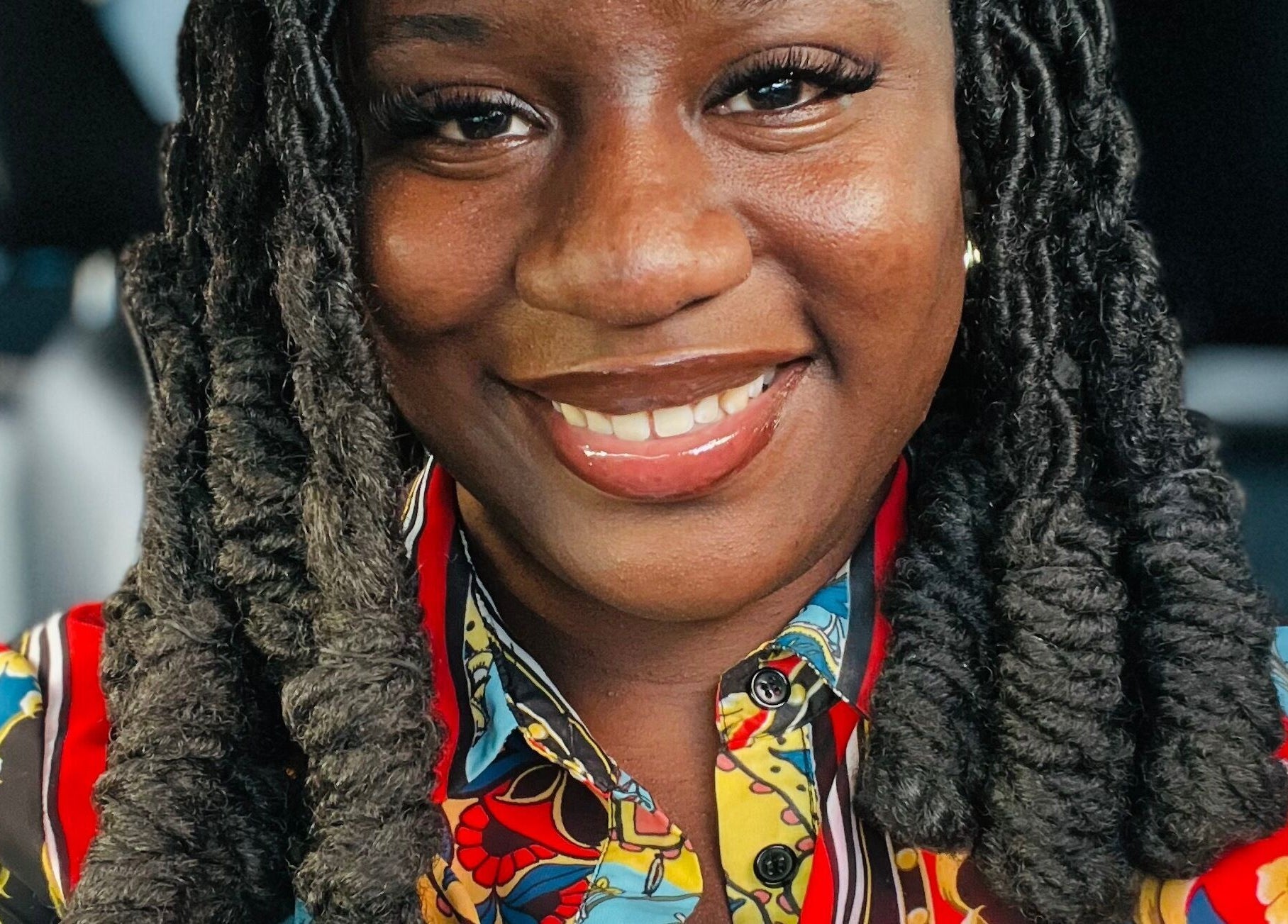 Woman with twisted braids at K’Luxe Braid Boutique, Portmore, St. Catherine, JM, smiling brightly.