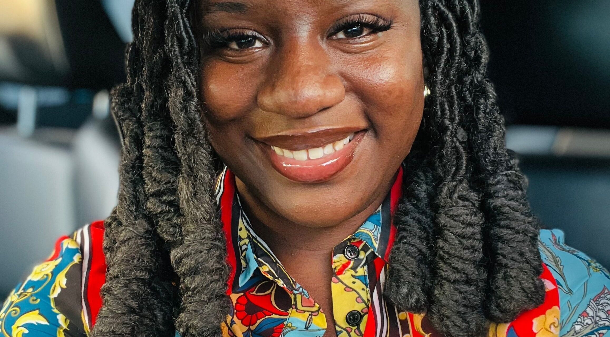 Woman with twisted braids at K’Luxe Braid Boutique, Portmore, St. Catherine, JM, smiling brightly.