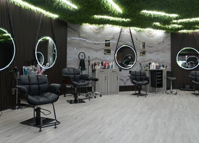Modern interior of Revive Hair Salon in Los Angeles, California, US featuring stylish mirrors and seating.