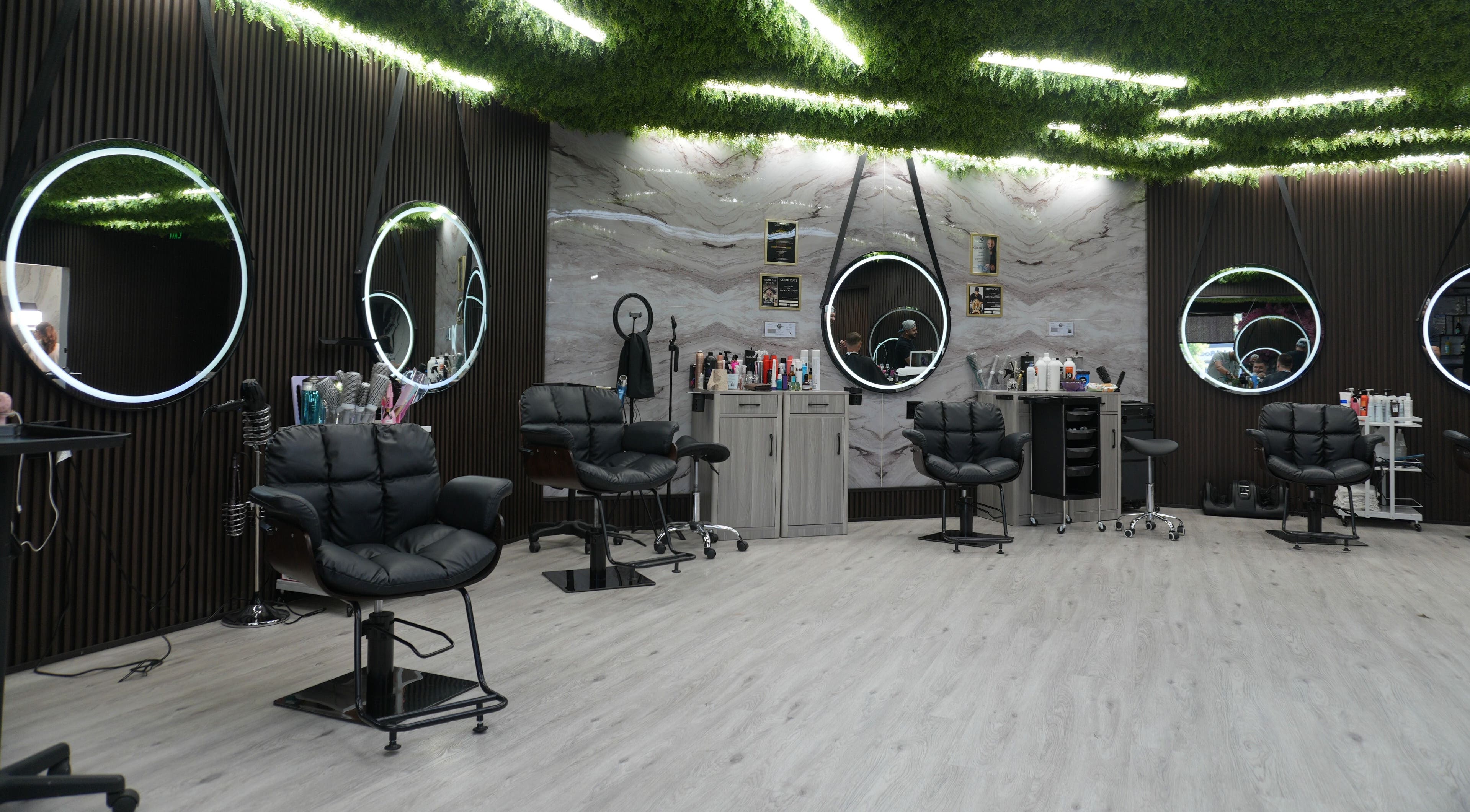 Modern interior of Revive Hair Salon in Los Angeles, California, US featuring stylish mirrors and seating.