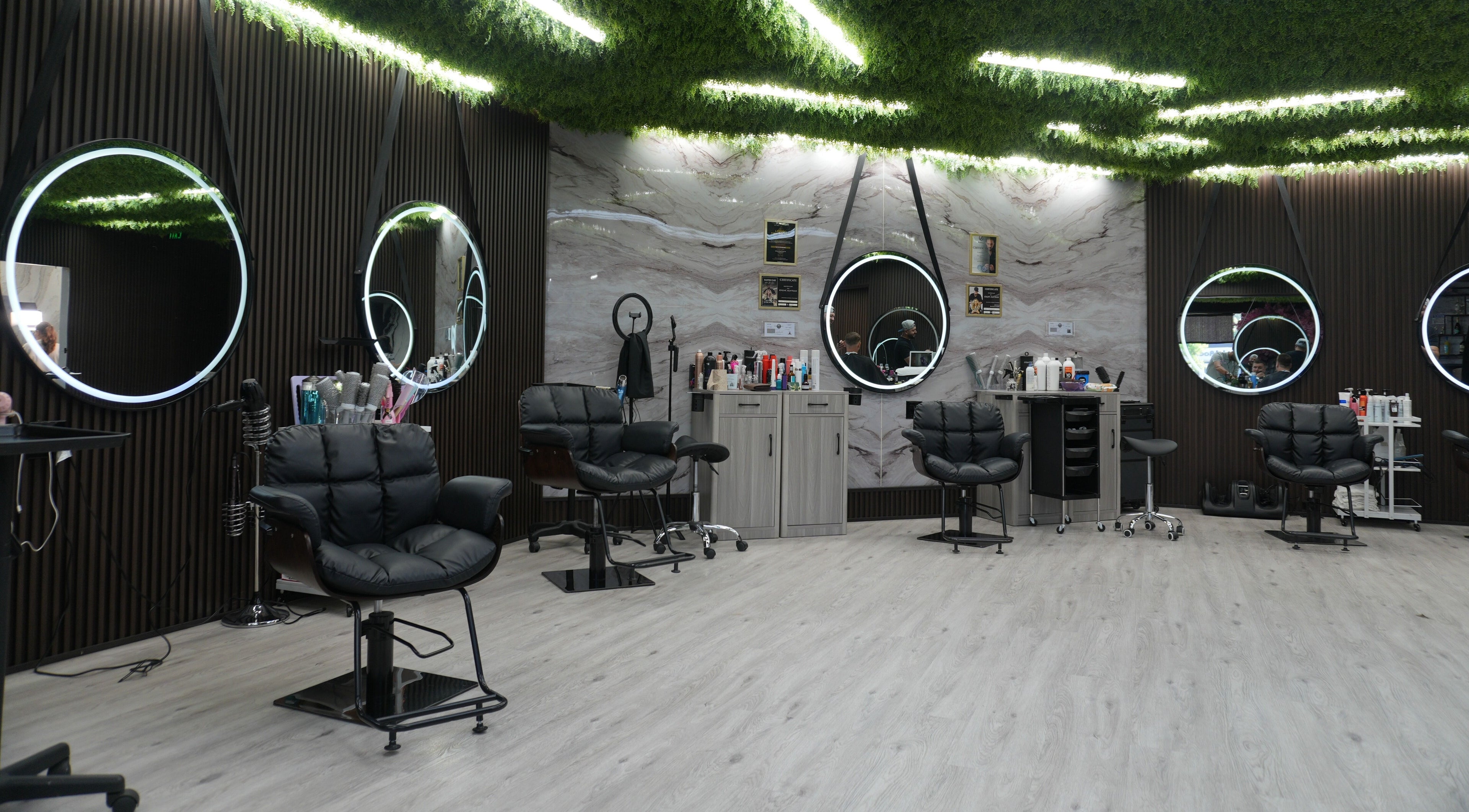 Modern interior of Revive Hair Salon in Los Angeles, California, US featuring stylish mirrors and seating.