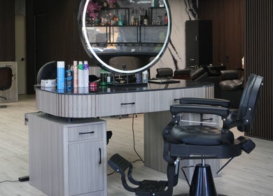 Modern styling station at Revive Hair Salon, Los Angeles, California, US with sleek decor and beauty products.