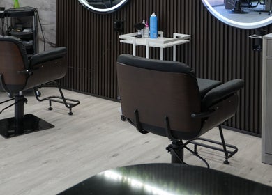 Stylish salon chairs at Revive Hair Salon in Los Angeles, California, US; modern interior ambiance.