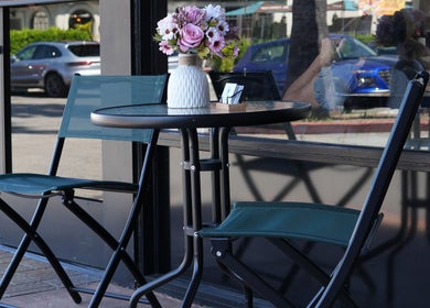 Outdoor seating with flowers at Revive Hair Salon, Los Angeles, California, US.