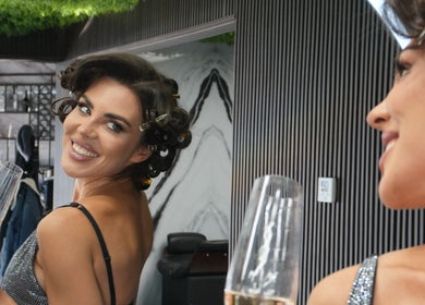 Woman in mirror enjoying a drink at Revive Hair Salon, Los Angeles, California, US.