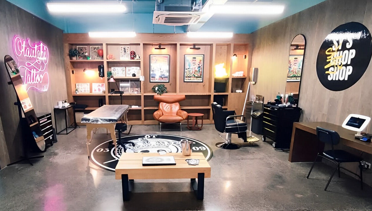 Trendy Sy's Chop Shop interior with neon sign and cozy seating in Auckland, NZ.