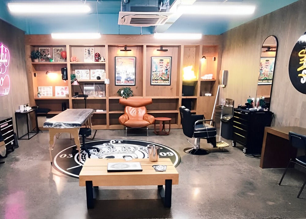 Trendy Sy's Chop Shop interior with neon sign and cozy seating in Auckland, NZ.