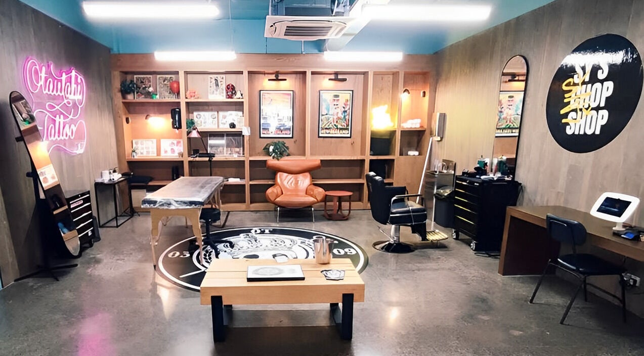 Trendy Sy's Chop Shop interior with neon sign and cozy seating in Auckland, NZ.