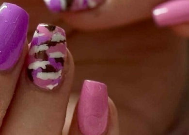Colorful nail art at Artisan Nails in Mosgiel, Otago, NZ showcasing detailed purple and pink designs.