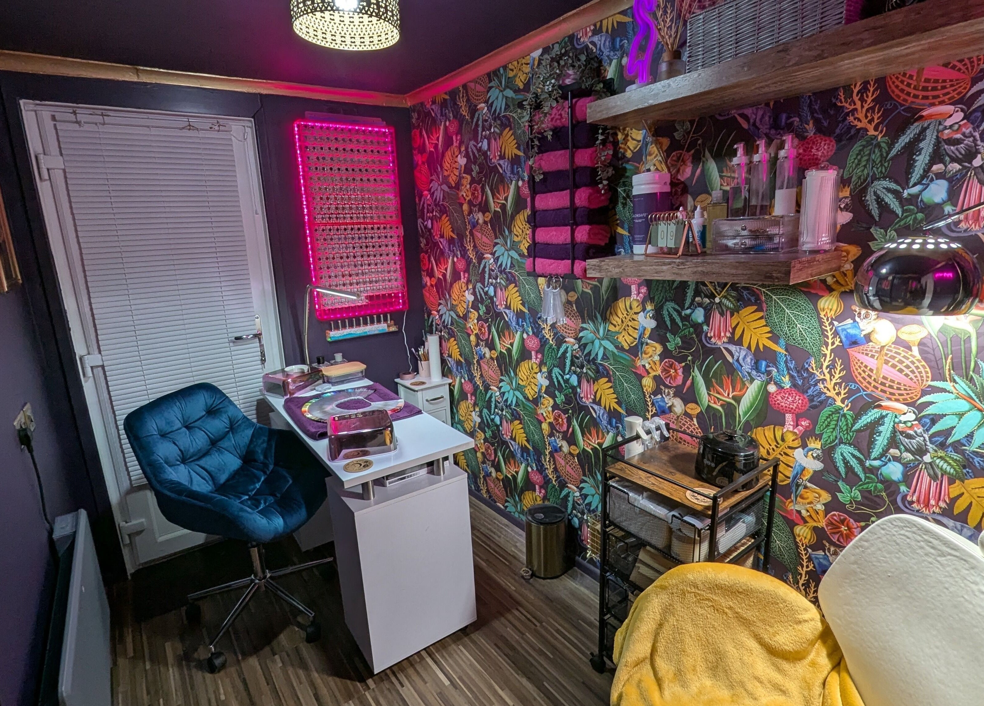 Vibrant nail studio at The Nailbox Netherton, Dudley, England, GB with colorful floral wallpaper.