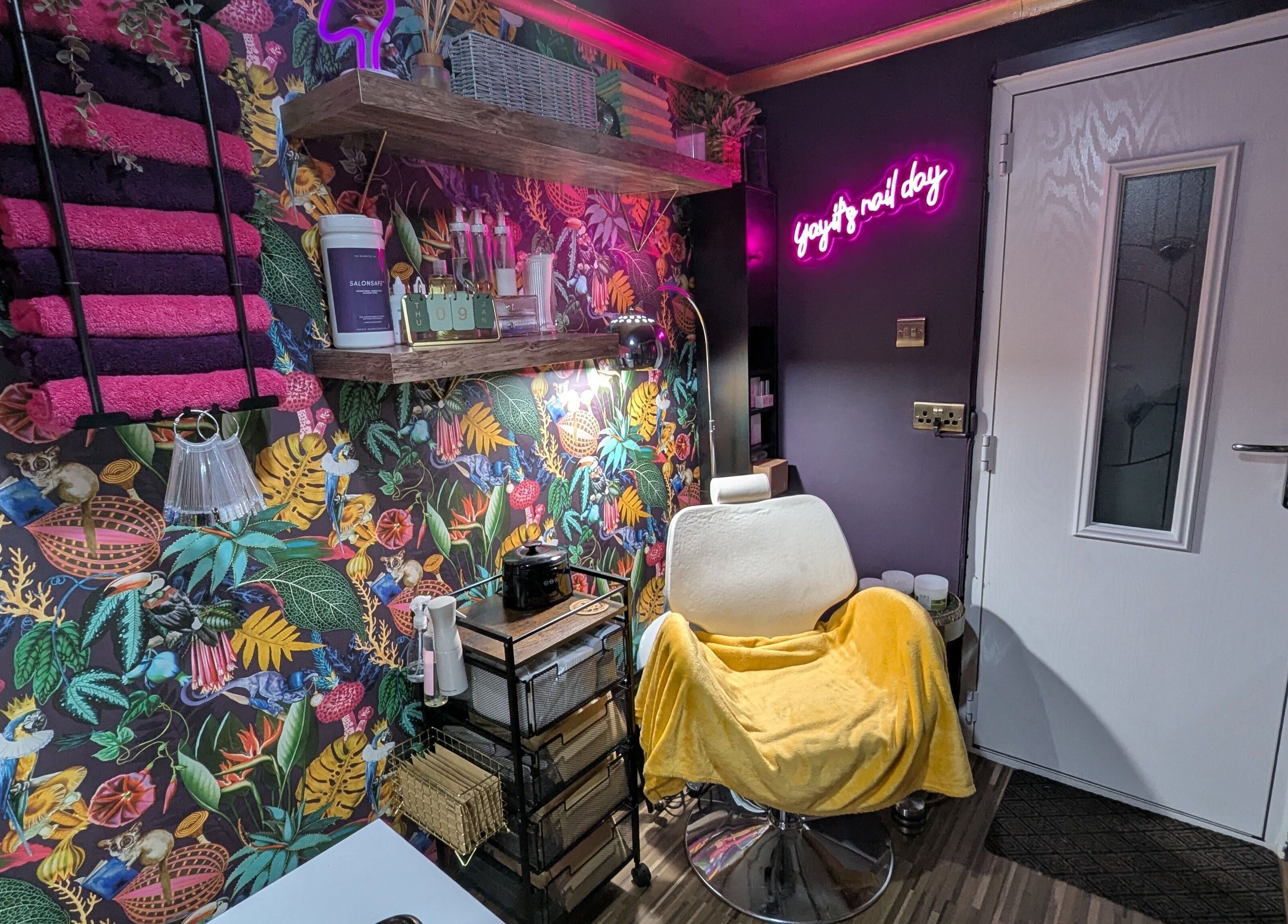 Colorful beauty space at The Nailbox Netherton, Dudley, England, GB with botanical wallpaper and salon chair.