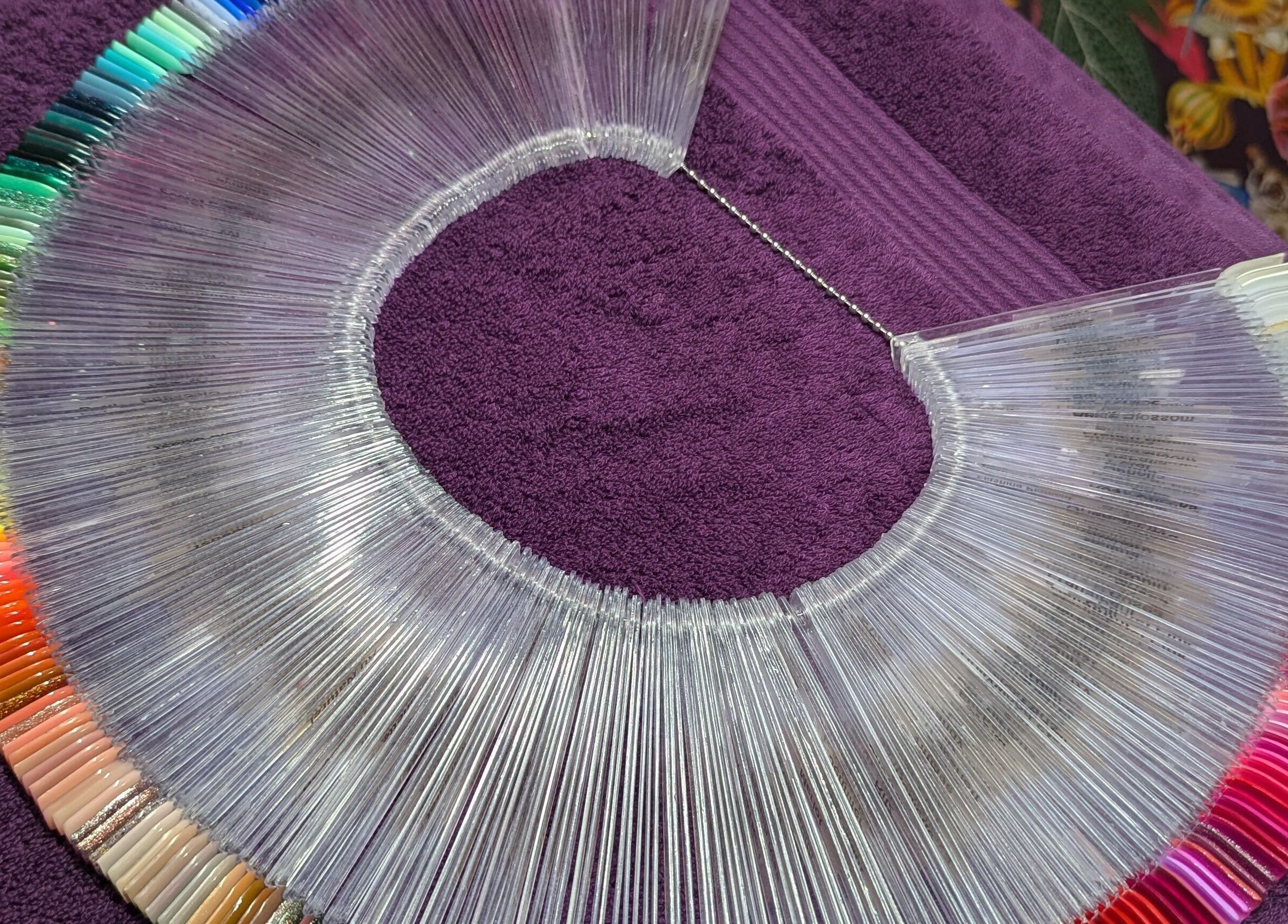 Colorful nail polish selection at The Nailbox Netherton, Dudley, England, GB, on a purple towel.