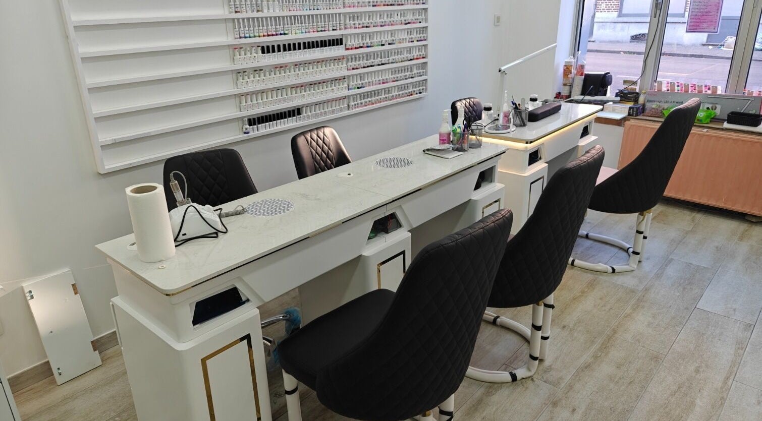 Intérieur moderne de Namur Nails à Namur, Région Wallonne, BE avec tables de manucure et chaises noires.