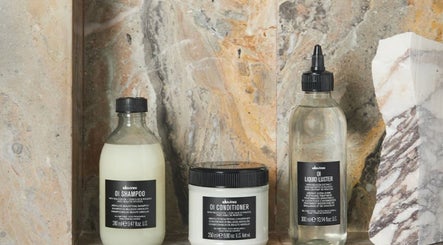 Hair care products display at Cora and Co, Teignmouth, England, GB. Featuring shampoo, conditioner, and liquid luster.