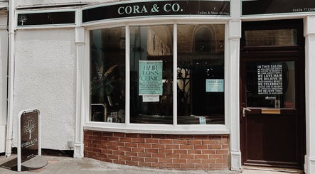 Entrance of Cora and Co beauty salon, Teignmouth, England, showcasing stylish exterior and signage.