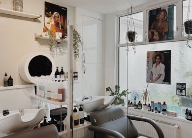 Modern salon interior at Cora and Co, Teignmouth, England with stylish decor and premium hair products.