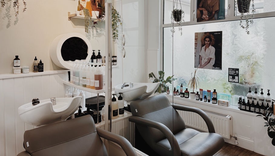 Interior of Cora and Co, Teignmouth, England, showcasing salon chairs and beauty products.